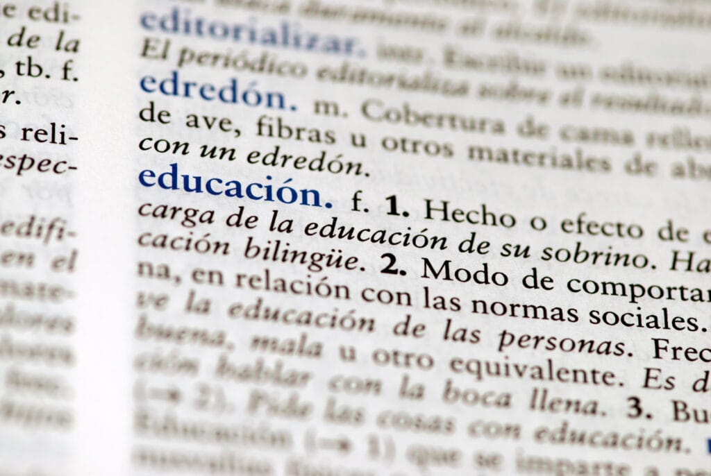 Spanish dictionary definition of the word education, representing a student working through a Spanish class vocabulary lesson