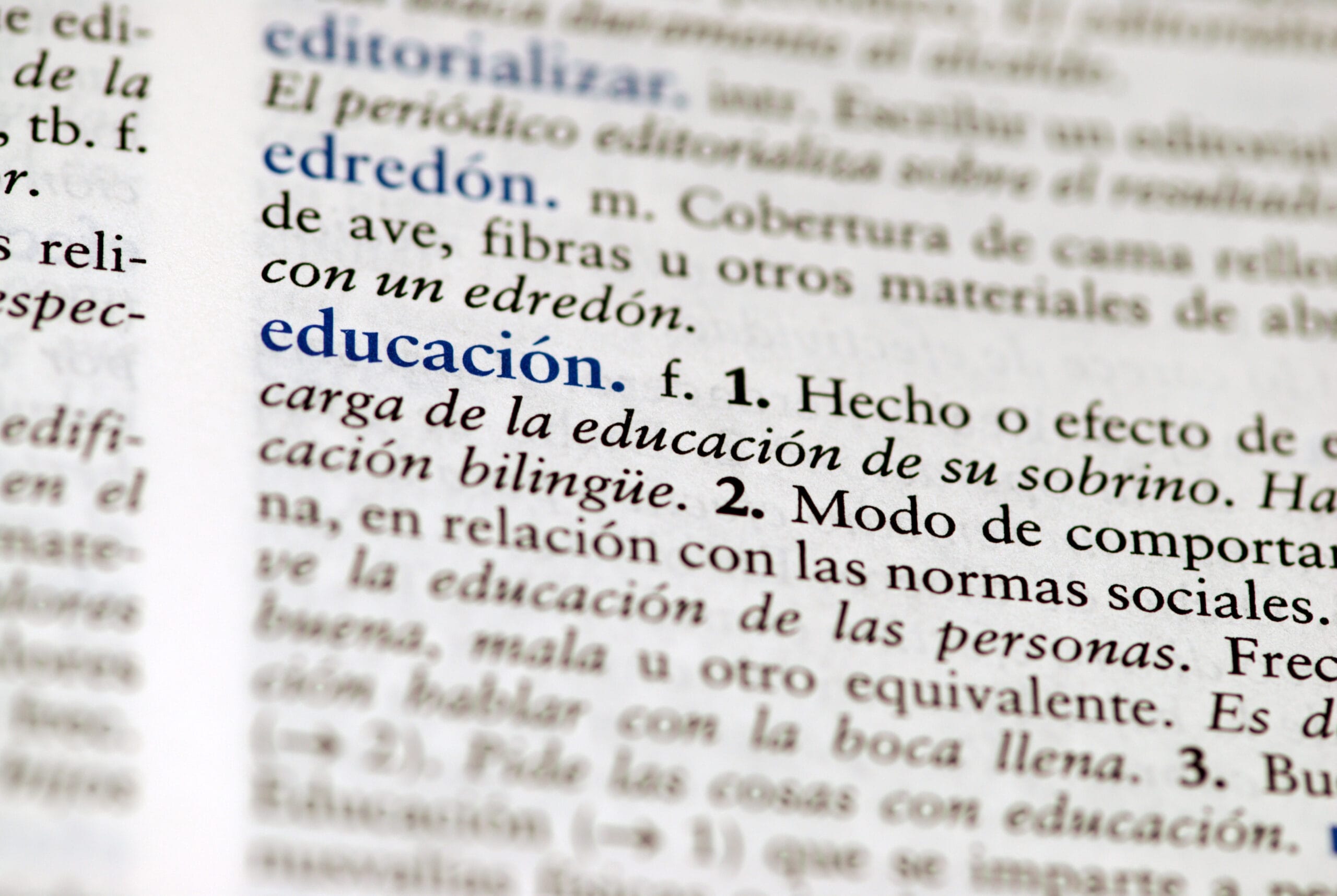 Spanish dictionary definition of the word education, representing a student working through a Spanish class vocabulary lesson