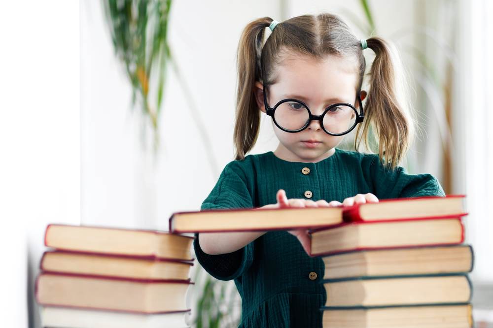 Young student building confidence to work through math anxiety while studying with books
